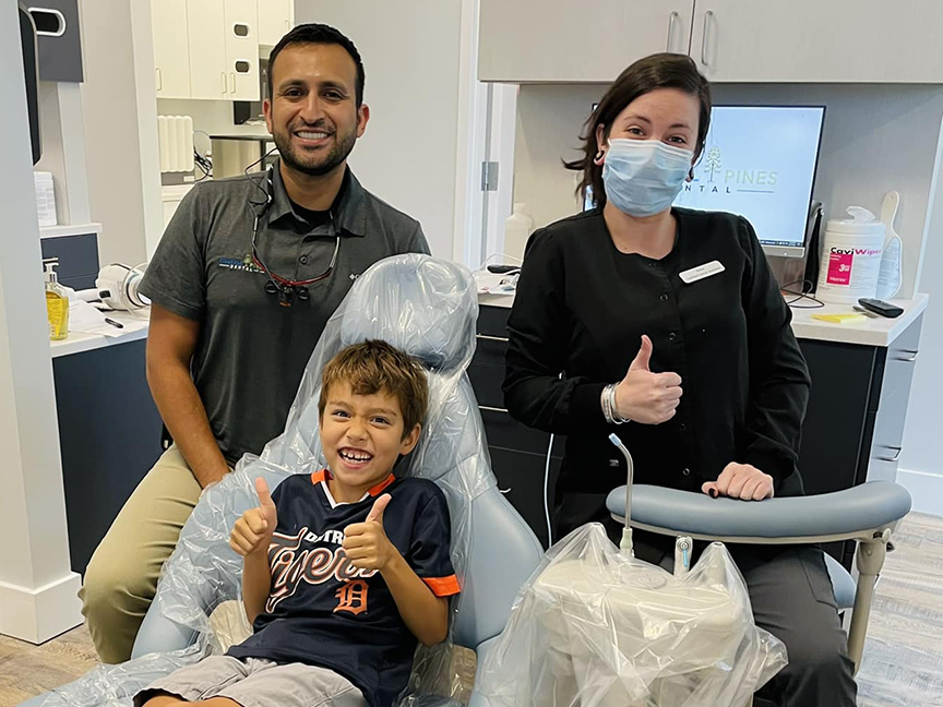 A child gets teeth cleaned at Coastal Pines Dental