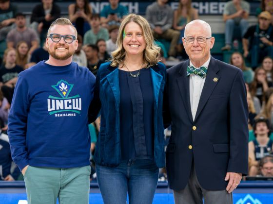 2026 Distinguished Alumni Honorees standing on a basketball court
