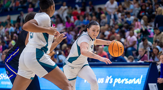 UNCW women's basketball team on court during game