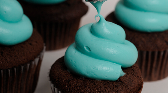 teal icing on chocolate cupcake