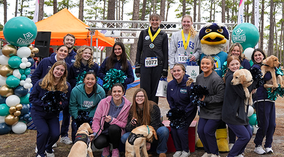 Runners gathered for photo with Sammy C. Hawk