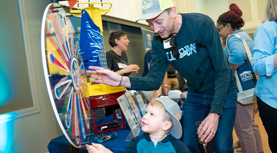 parent and child spinning the wheel