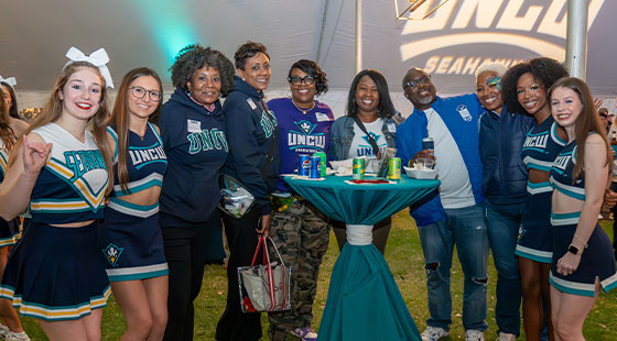 Alumni with cheerleaders at TEALgate