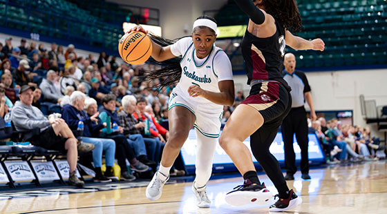 UNCW women's basketball team on court during game