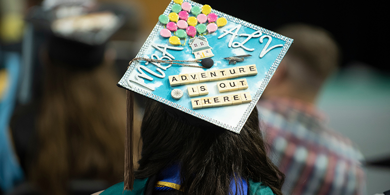 "Adventure is out there" on graduation cap