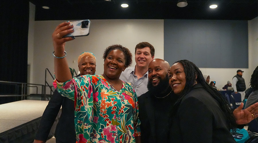 A group selfie being taken at an AAGA event