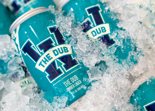 Cans of The Dub Amber Lager in ice
