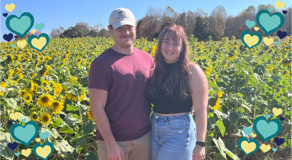 A photo of Jordan Tanley and Chase Webb in a sunflower field