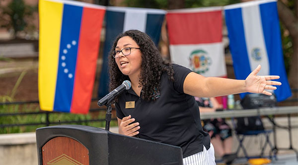 Mayra Robles speaking from a podium