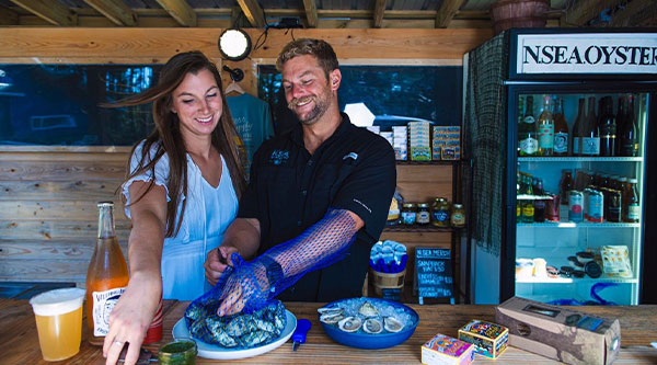 Connor and Alyssa serving oysters