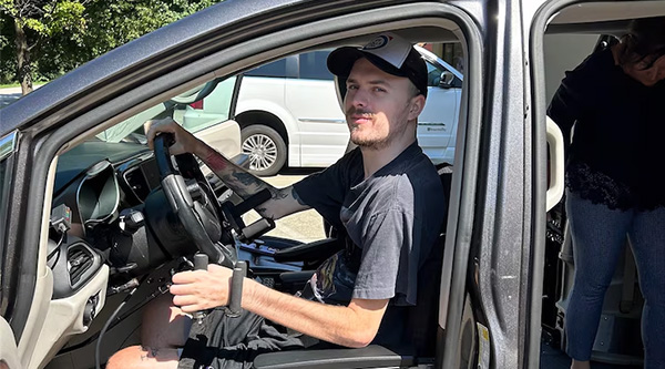 Ryley Hopper behind the wheel of a specially equipped van