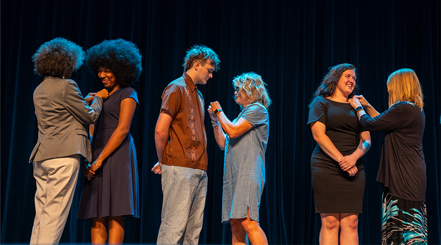 UNCW legacy students receiving pins