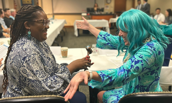 Stephania receiving the gavel from Allison at the Alumni Association Board of Directors meeting