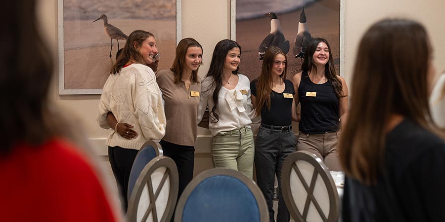 A group of student ambassadors pose together for a photo.