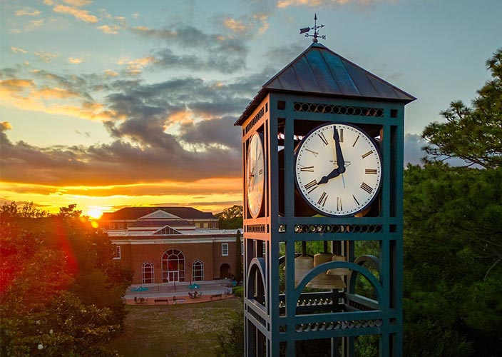 An image of the UNCW Clocktower overlooking Randall Library