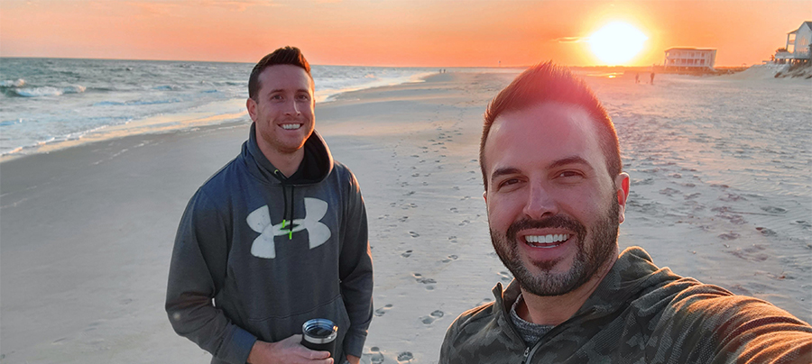 Zach Shelton and husband Eric on the beach